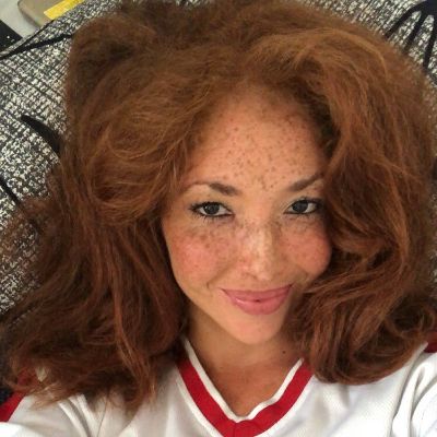 Natasha Culzac taking a selfie for her Instagram while lying down.